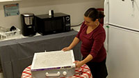 Woman making a box fan filter