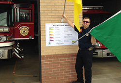 Fireman waving air quality flags