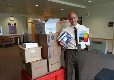 Dr. John Patten receives flag kits for the Alpine School District, UT.